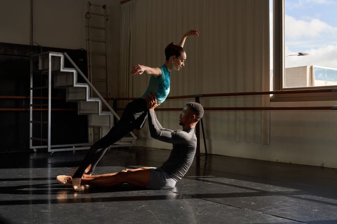 Couple of Black male and white female in a class doing a training in ballet academy