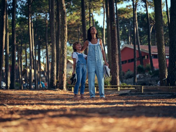 Mother and son in campsite at woods