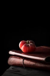 Fresh tomato on old books