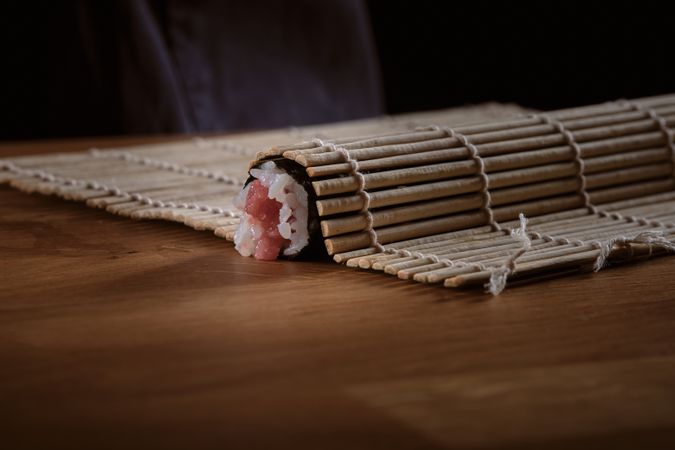 Male shushi man hands preparing different pieces of makis