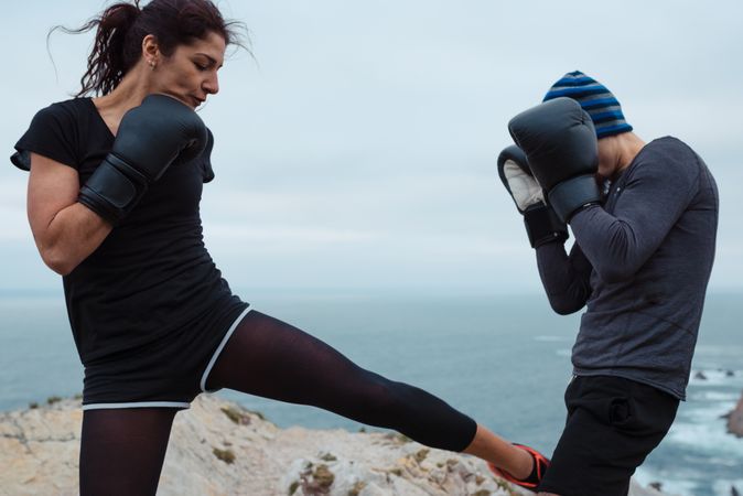 Boxers exercising on cliff