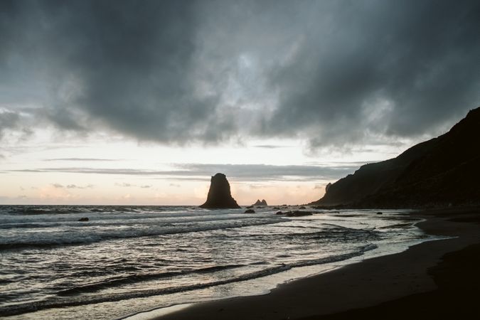 Lonely cliff in sea on cloudy day