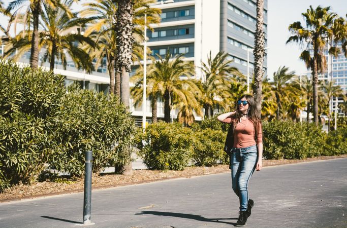 Teen girl walking happily through the streets.