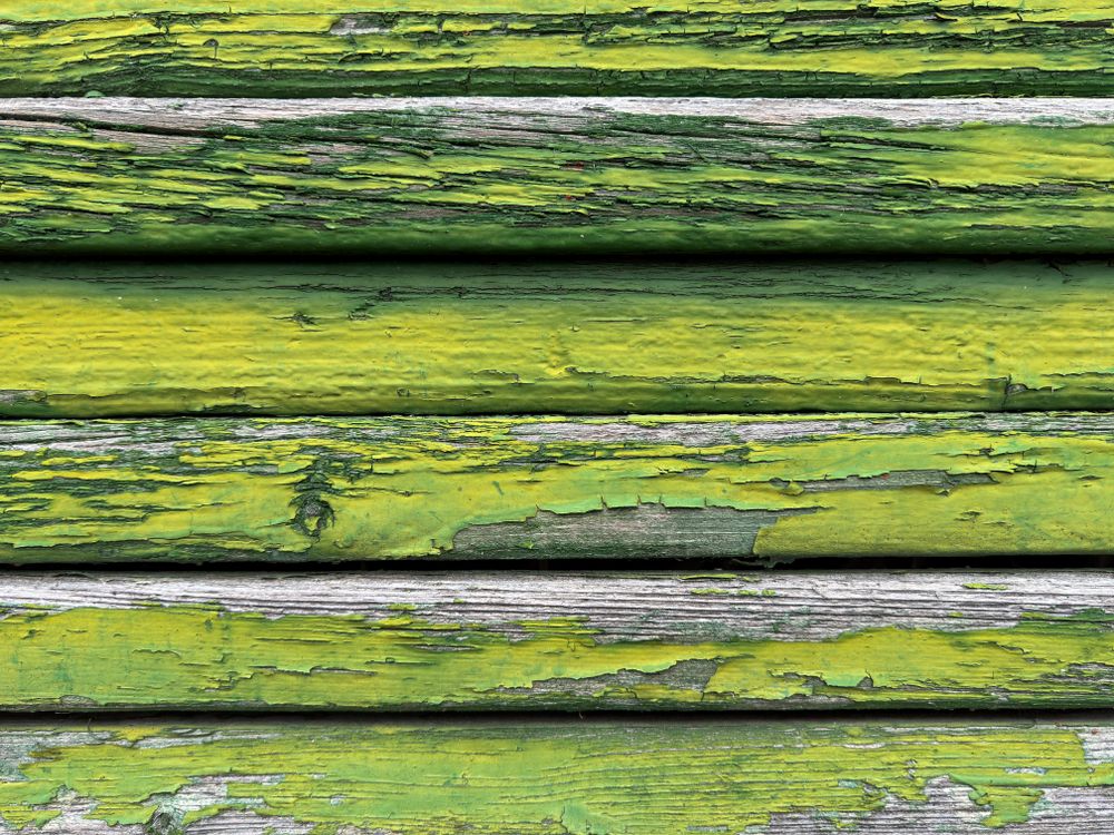 Peeling green paint on boards
