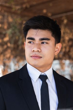 Asian businessman standing in street