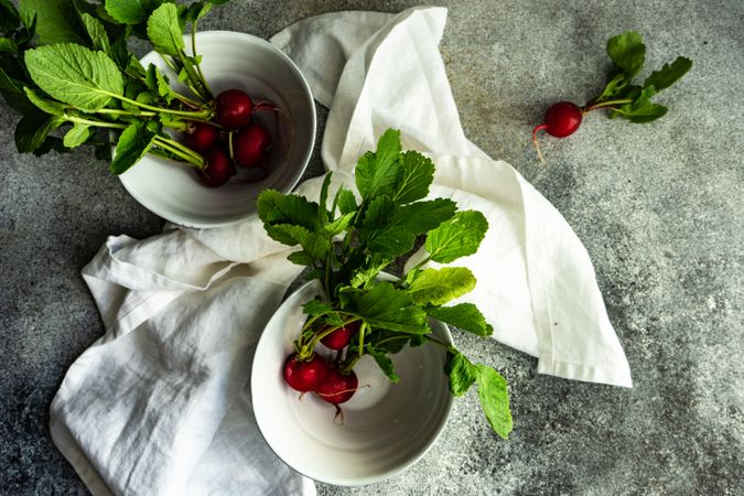 Top view of fresh radishes in bowls