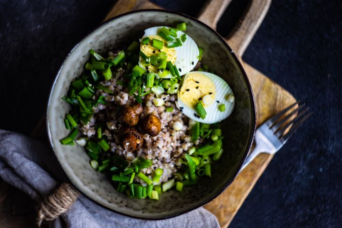 Top view of buckwheat bowl with hard boiled eggs and mushroom