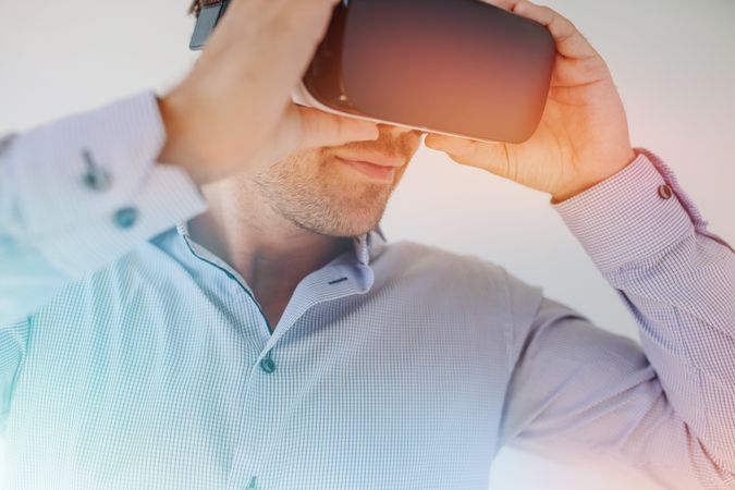 Man using VR glasses with sun flare effect