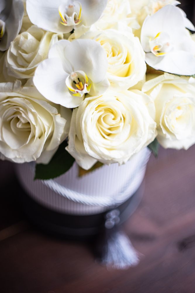 Close up of gift box with roses and orchids