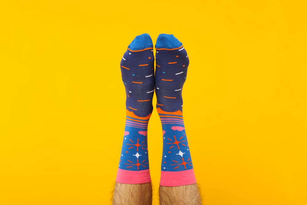 Concept of clothes for legs - socks, socks on male legs