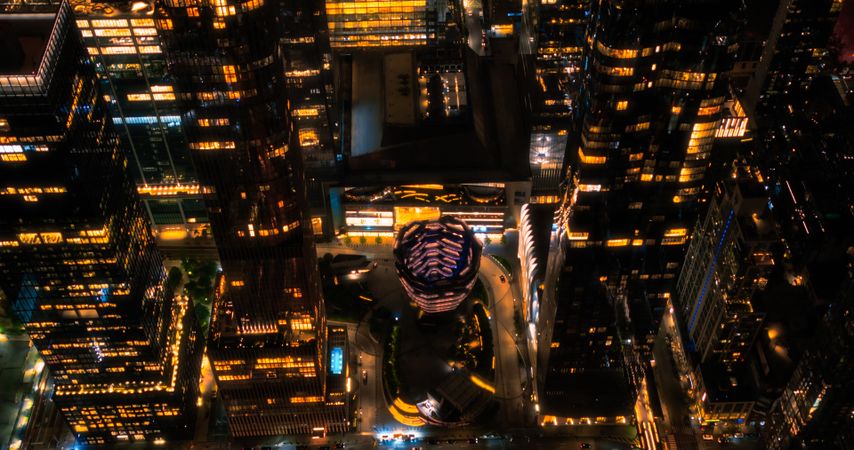 Helicopter Tour of New York Cityscape at Night. Manhattan with Panorama of Office Buildings with Lights and Congested Streets with Cars and Taxi Vehicles in a Big City