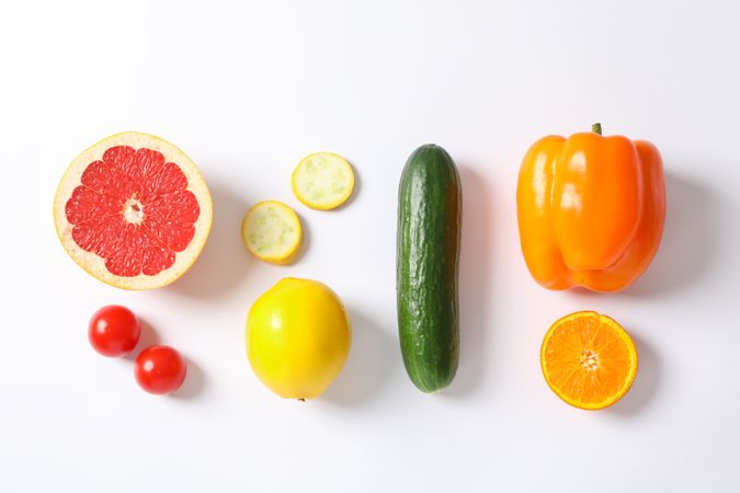 Flat lay with vegetables and fruits on plain background, space for text