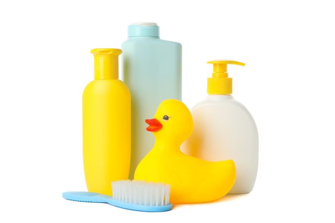 Bathroom bottles and rubber duck isolated on light background