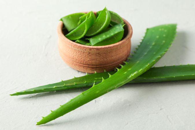 Aloe vera leaves and slices on table, space for text and closeup. Natural treatment
