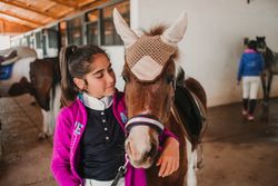 Girl with adorable pony in hat