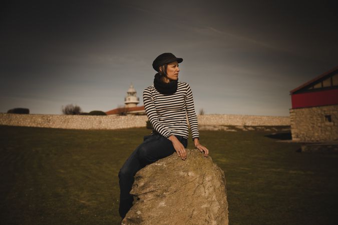 Woman and sitting on bench on shore near water