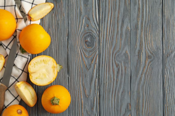 Round zucchini, knife and napkin on wooden background