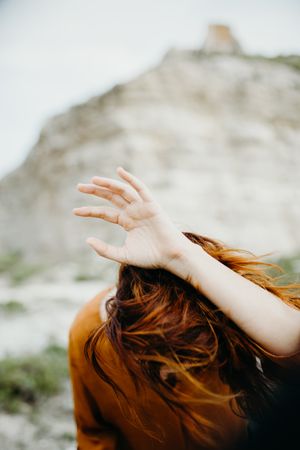 Dreamy attractive young woman posing outdoors