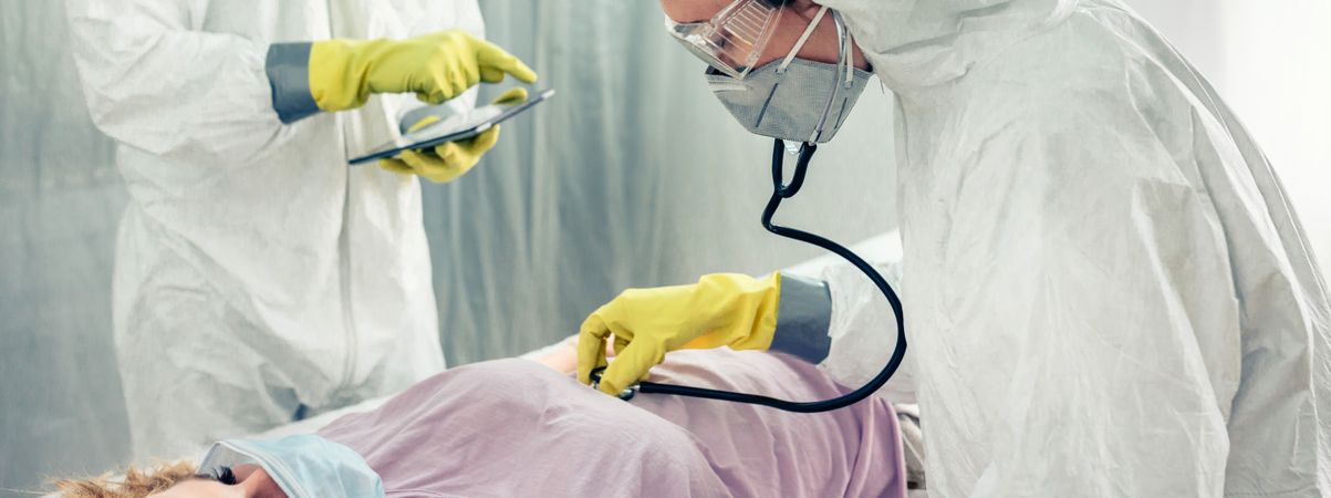 Doctors in a field hospital examining a patient