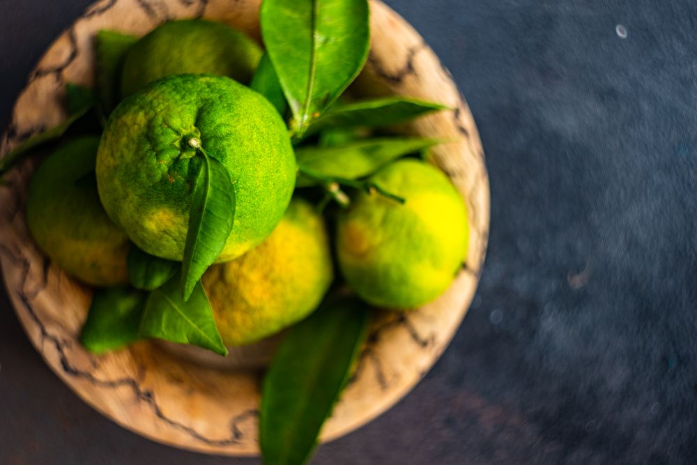 Top view of bowl of fresh green tangerines