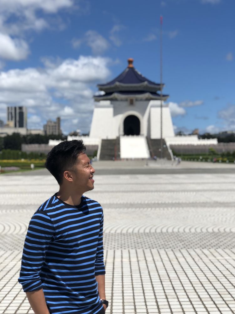 Man wearing blue t-shirt standing outdoor