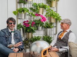 Trendy friends resting at table outdoors