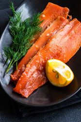 Herring fish on plate served with dill and lemon