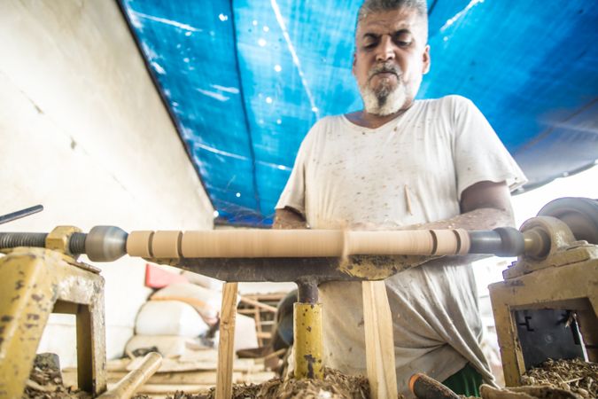 Man using woodworking machine at workplace