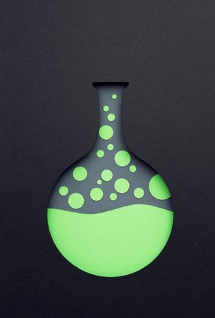 Paper cut out of chemistry beaker with half liquid