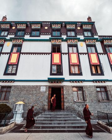 Buddhist monks standing beside a building