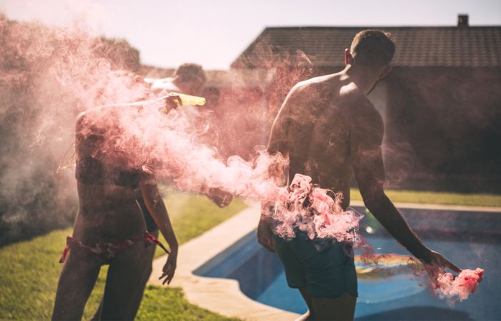 Friends lighting smoke torch