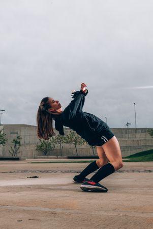 Female hip hop dancer in active wear striking pose outdoors