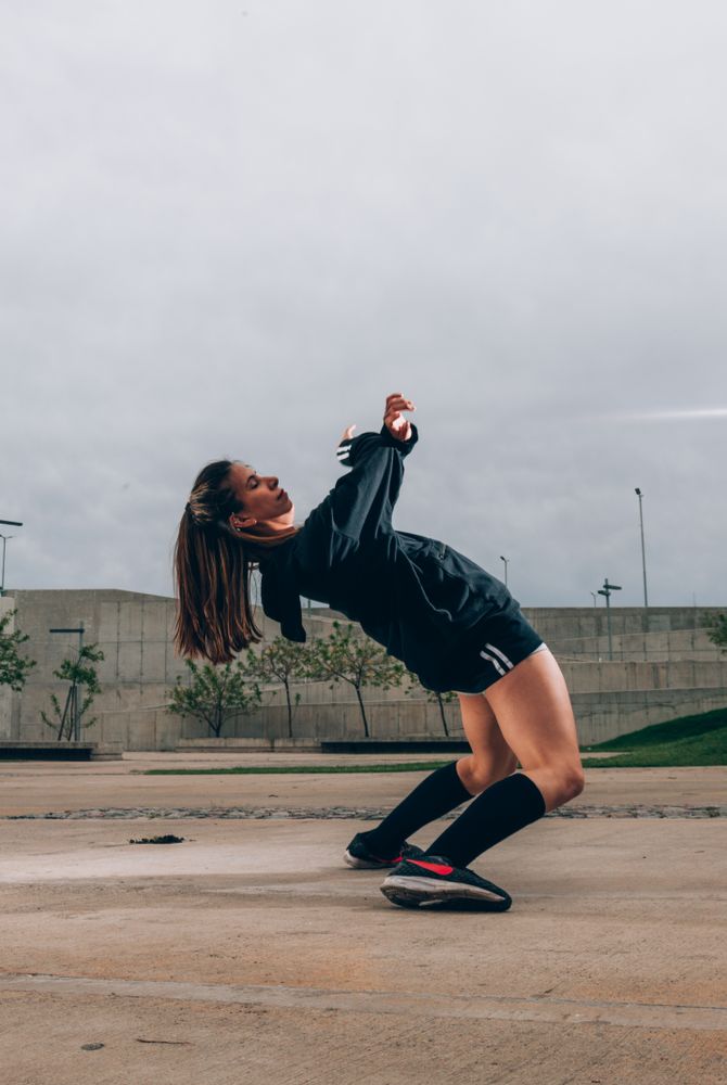 Female hip hop dancer in active wear striking pose outdoors