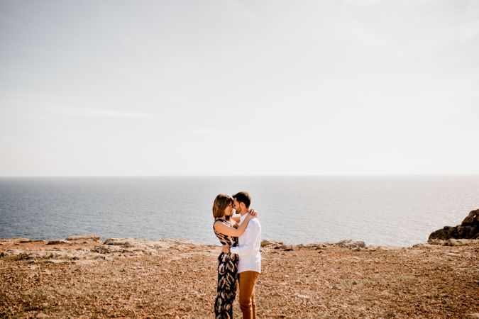 Tender lovers cuddling on seashore