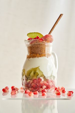 Delicious yogurt dessert with pomegranate, kiwi, grape and ginger biscuit