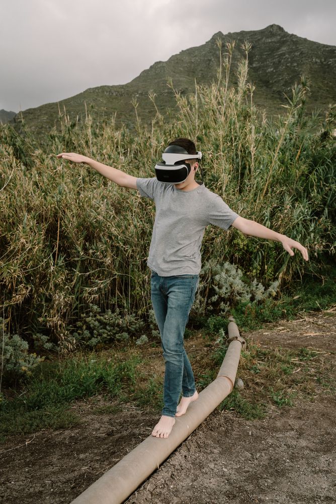 Young teenager with virtual reality glasses outdoors