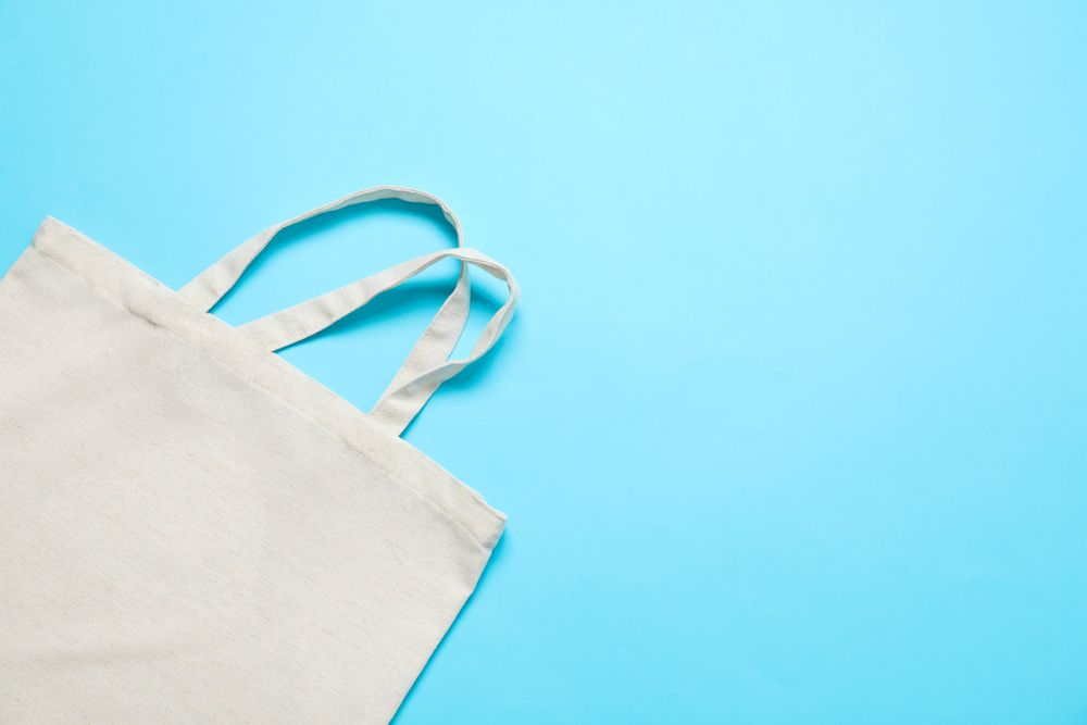 Eco bag on color background, space for text