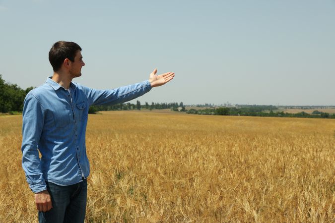 Young man in barley field. Agriculture business. Farming