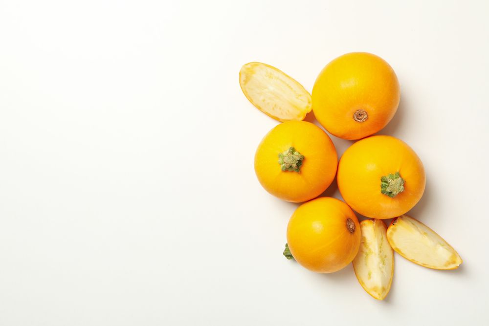 Round zucchini and slices on blank background, top view
