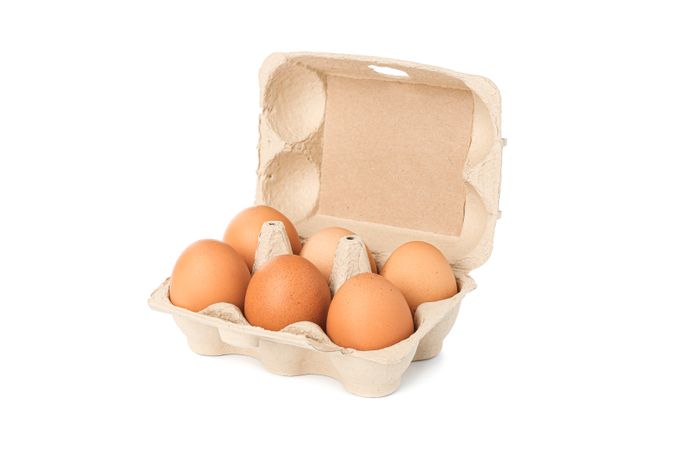 Brown chicken eggs in carton box isolated on light background