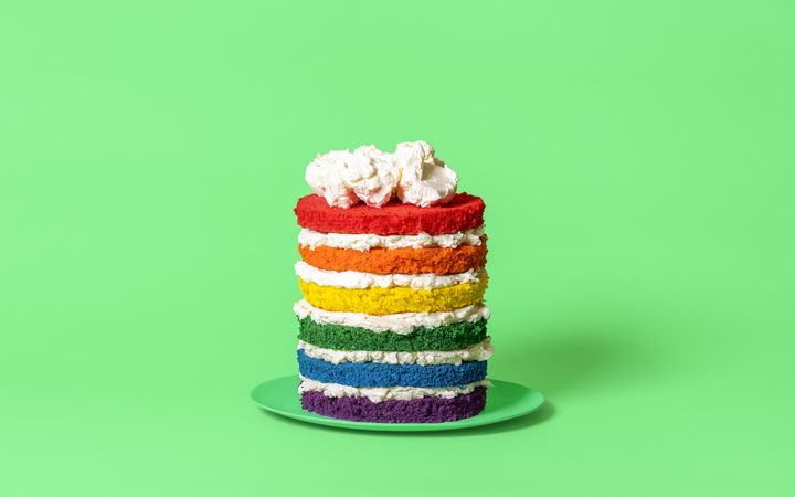 Rainbow cake isolated on a green background
