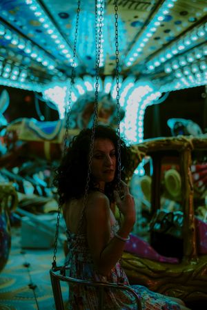 Woman enjoying ride on carousel