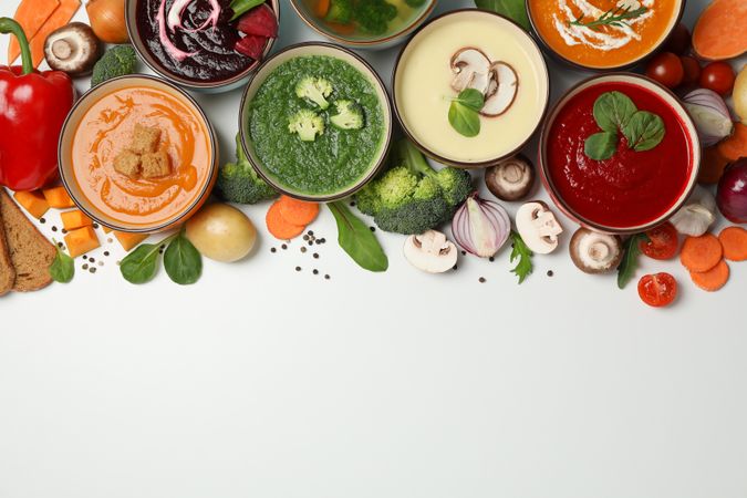 Colorful soups arranged on top of picture with copy space