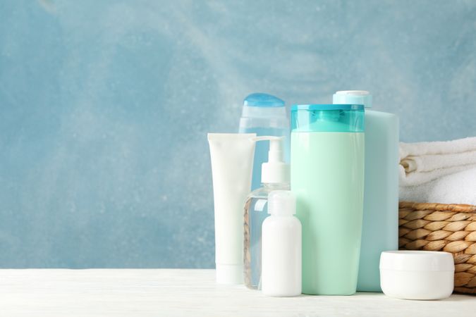 Body care products on blue background. Personal hygiene