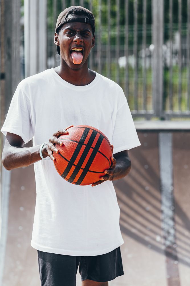 Black sportsmen with tongue out and looking at camera