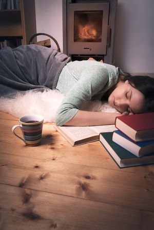 Sleeping woman surrounded by books