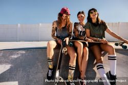 Group of female friends at skate park with their skateboards 4mnrXb