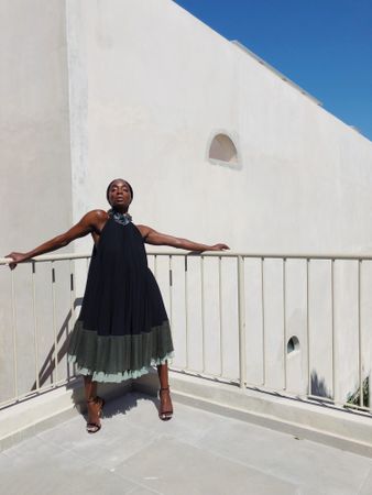 Woman in dark dress posing on balcony