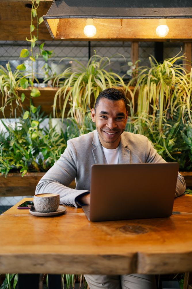 Man working on laptop at cafeteria