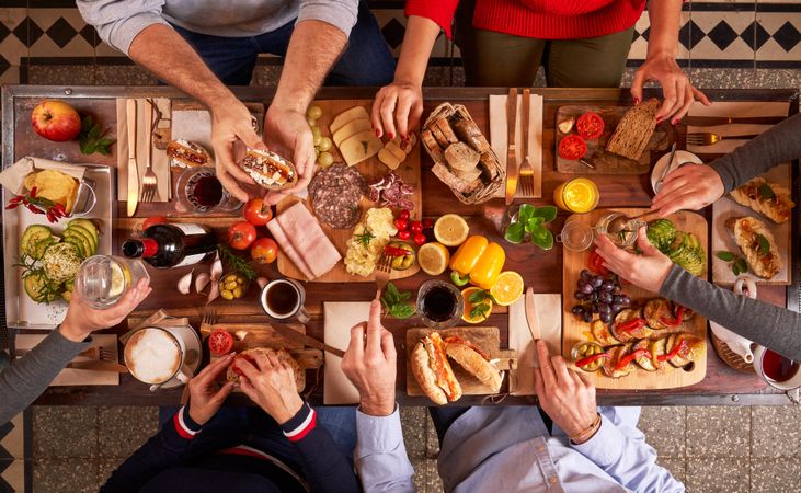 Unrecognizable people eating at served table